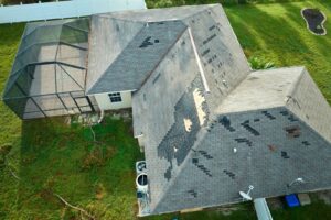 A damaged roof after a storm, showing signs of water damage.
